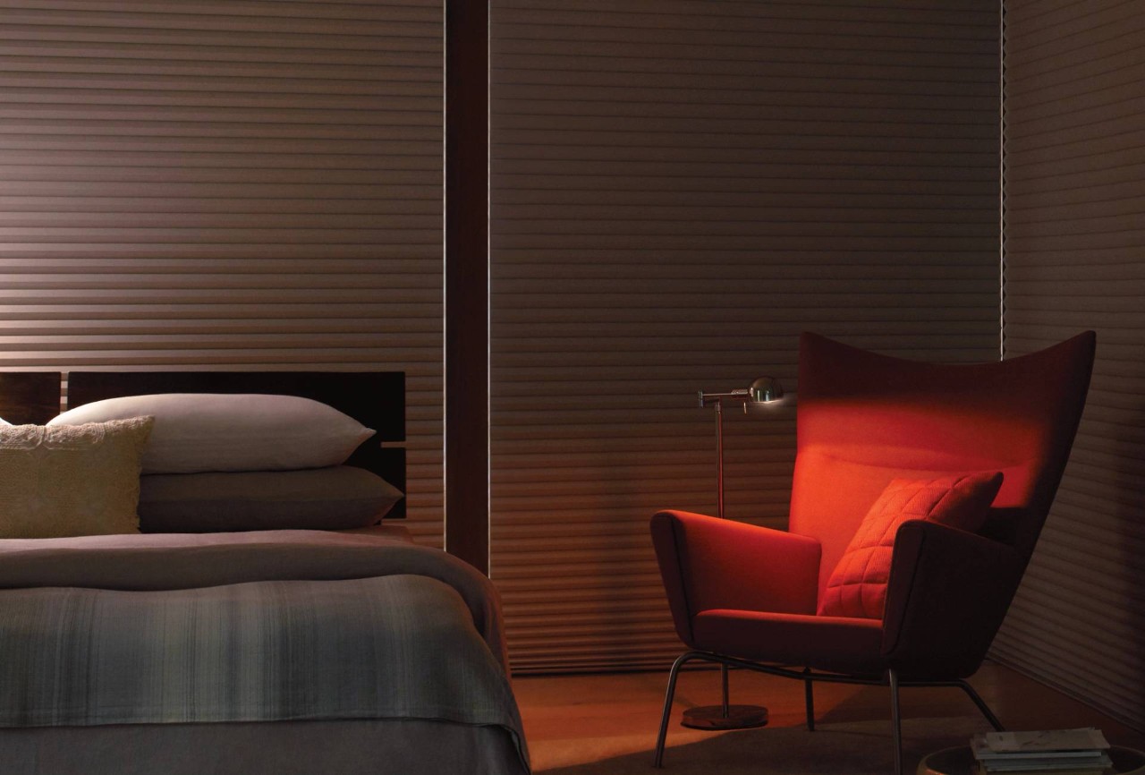 Dark bedroom equipped with light-blocking Hunter Douglas Duette® Cellular Shades 